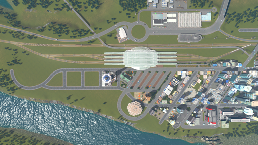 satellite view of a train station and tram plaza surrounded by dense buildings with a river