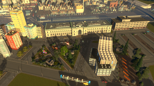 train station with a busy plaza in front of it and facilities for busses and trams
