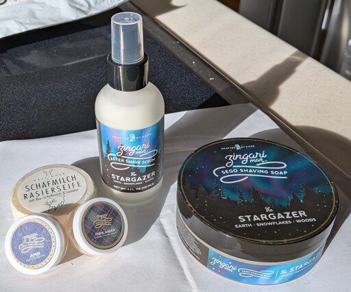 A smattering of shaving soap, shaving soap samples, and an aftershave balm.