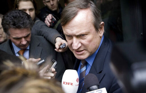 Peter Brixtofte outside court, surrounded by microphones, after being convicted in 2008